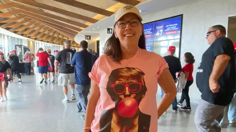 Trump supporter Maureen Liantonio wore a shirt showing Trump wearing pink sunglasses and blowing bubble gum.